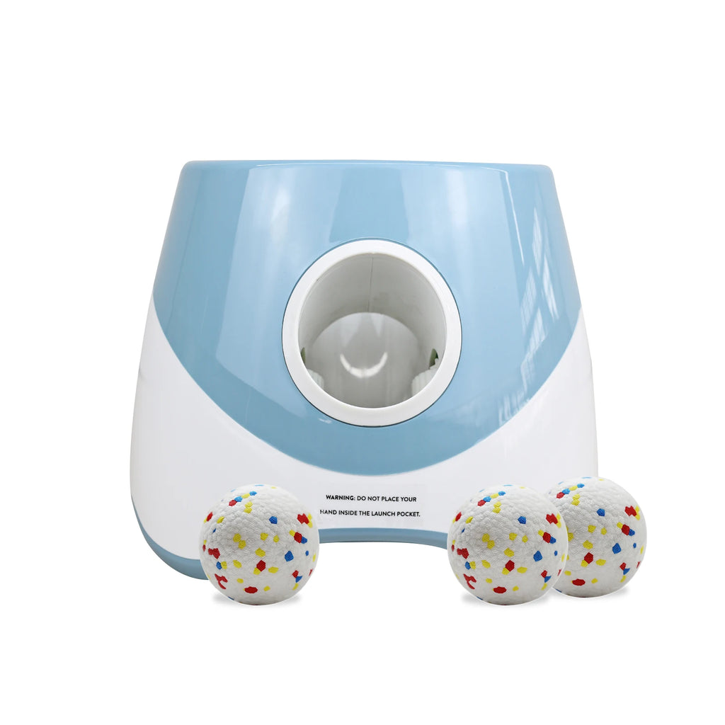 Zoomies Australia automatic dog ball launcher in blue and white with three colorful speckled balls